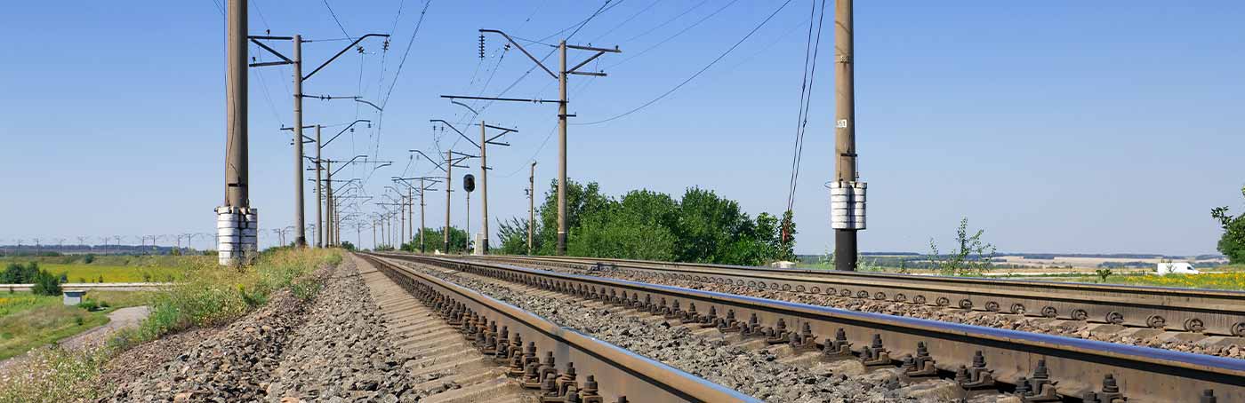 Railroad tracks stretching into the distance under a clear sky